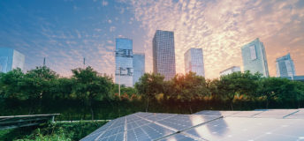 Solar Power Plant in modern city in sunset